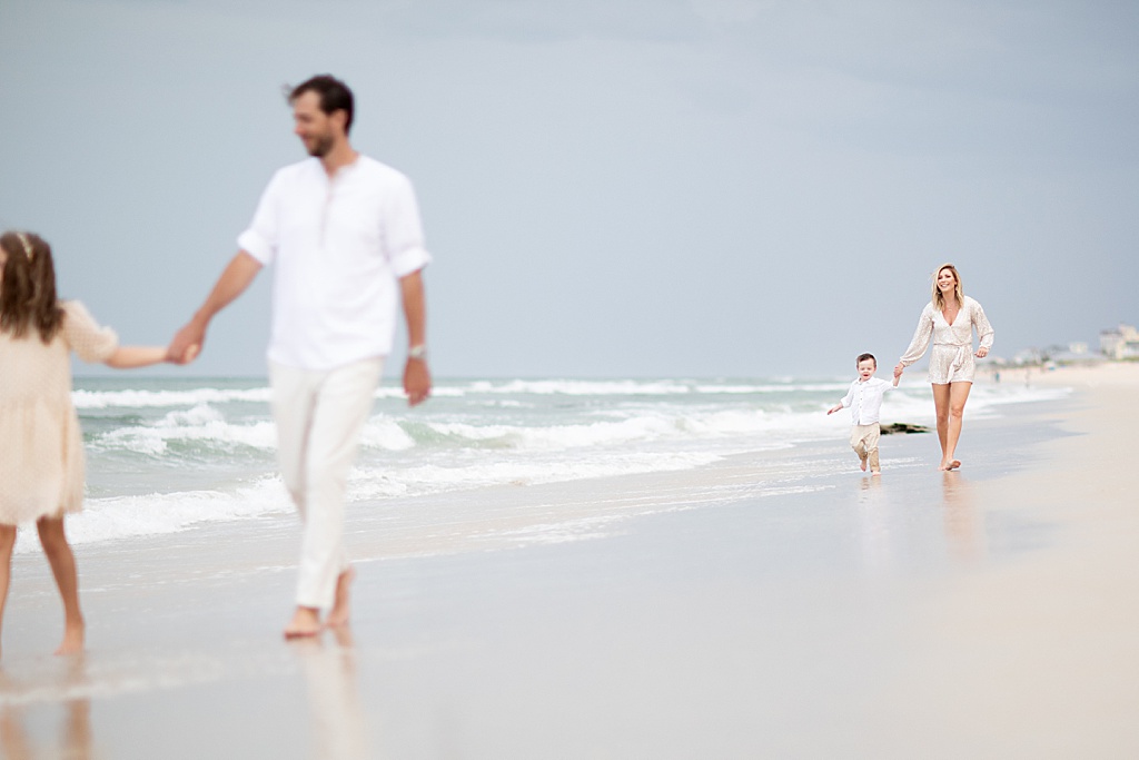 family walking along the beach at their sweet family beach session