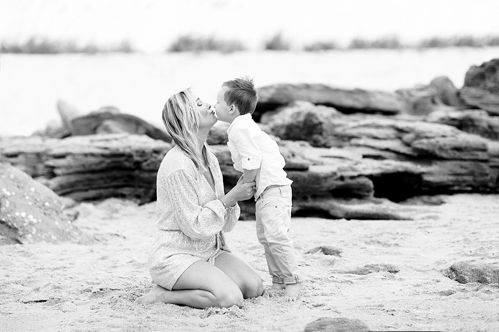 son almost kissing mom at their sweet family beach session