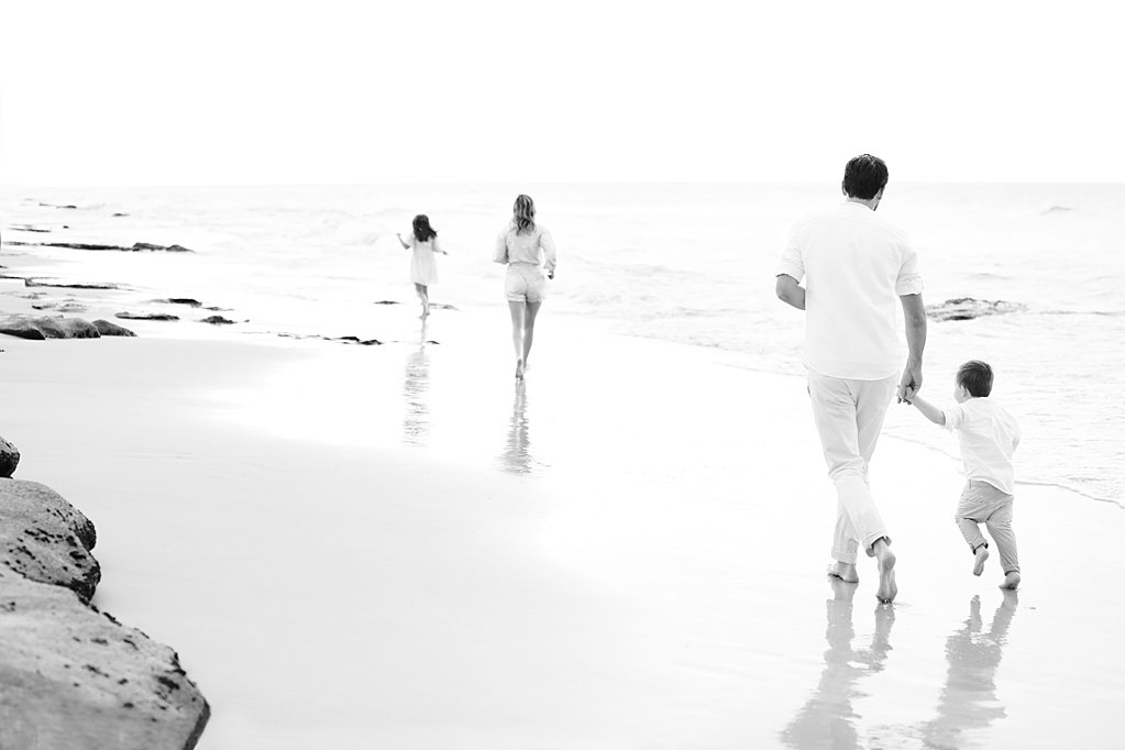family running down the beach