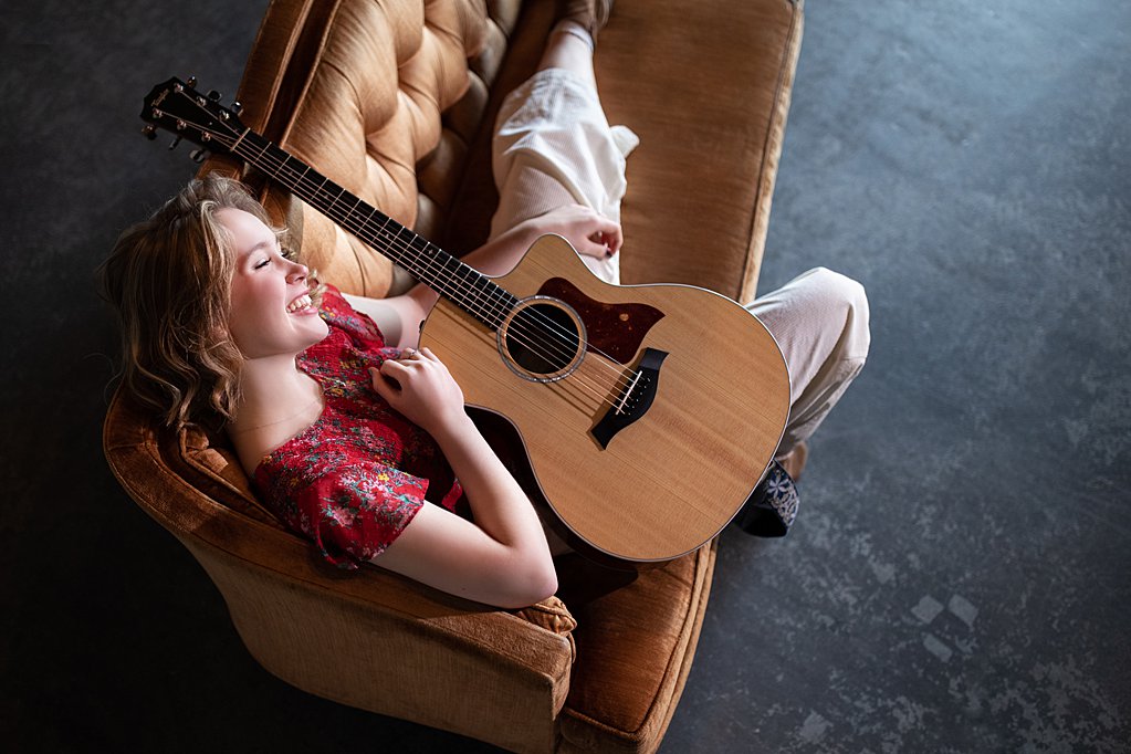 girl on couch with guitar during her senior session