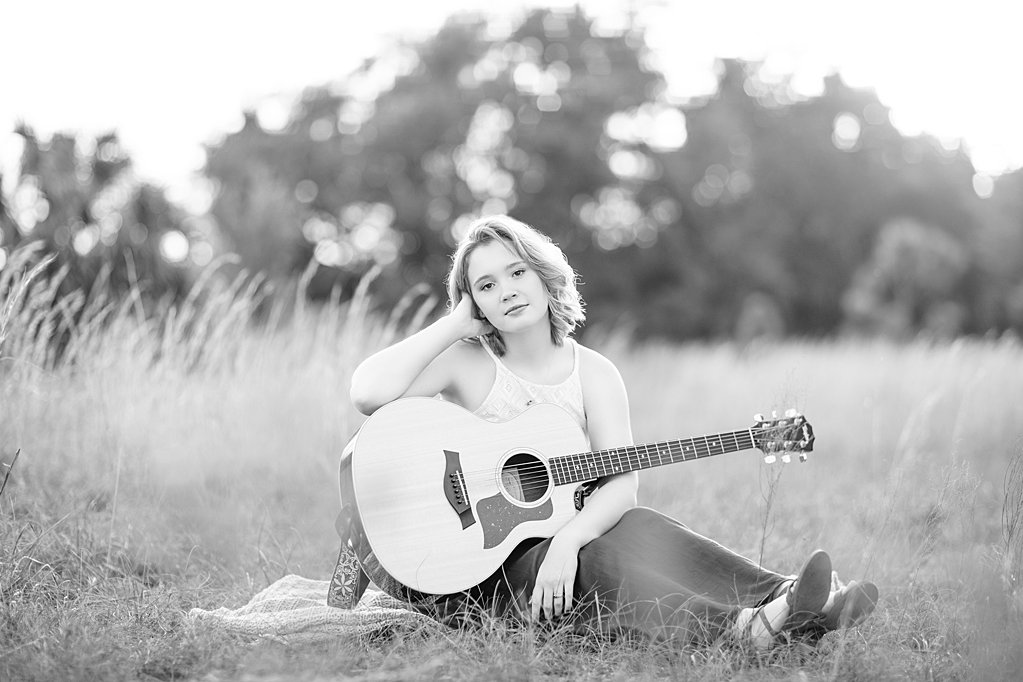 girl with guitar in field at senior session
