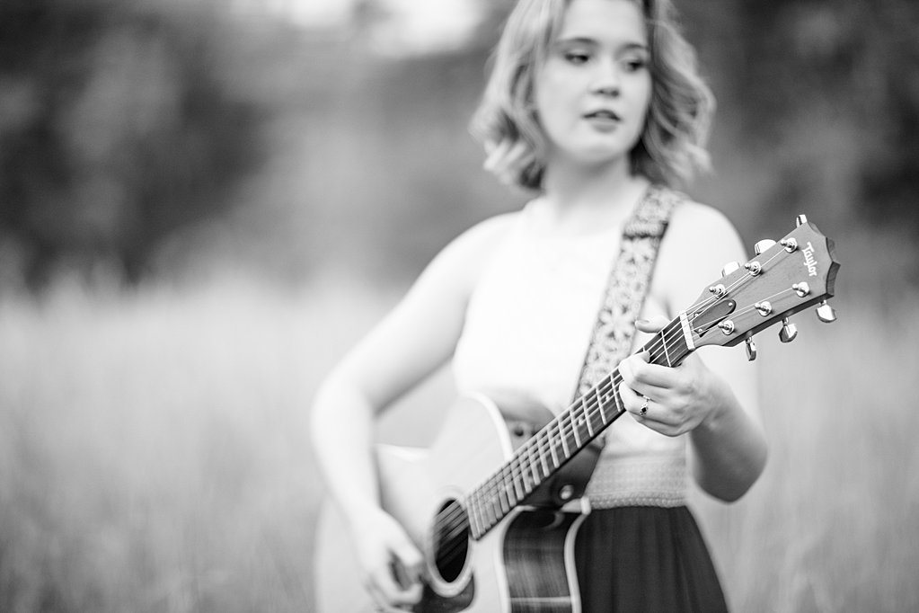 girl playing guitar hands in focus at senior session