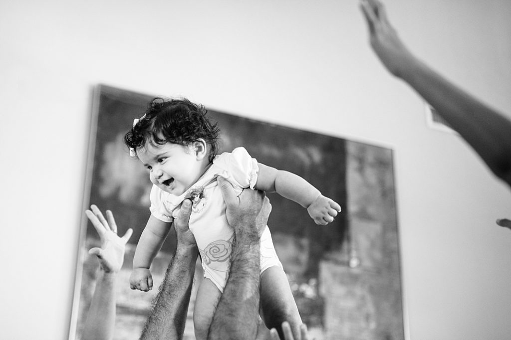 baby lifted into the air during family storyteller session