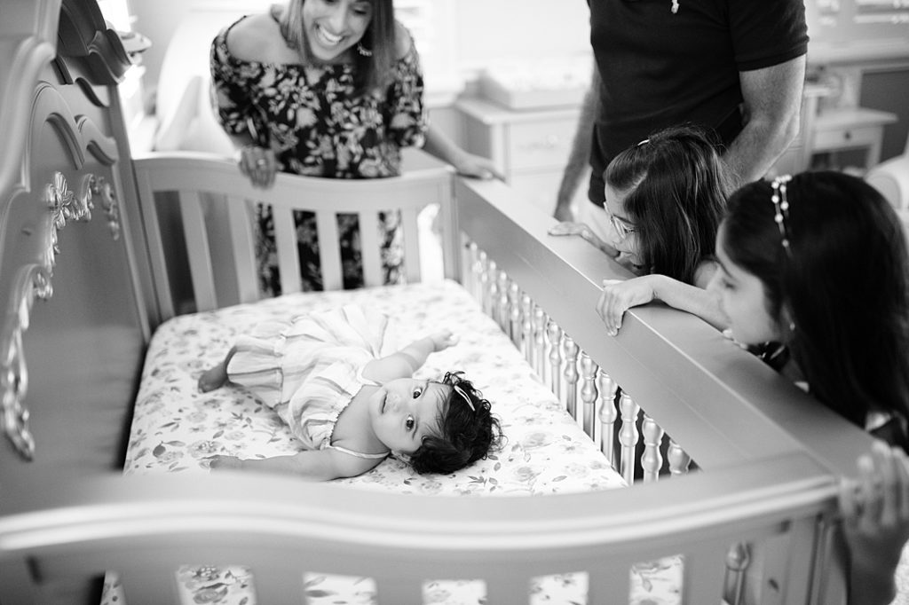 baby girl in crib at family storyteller session