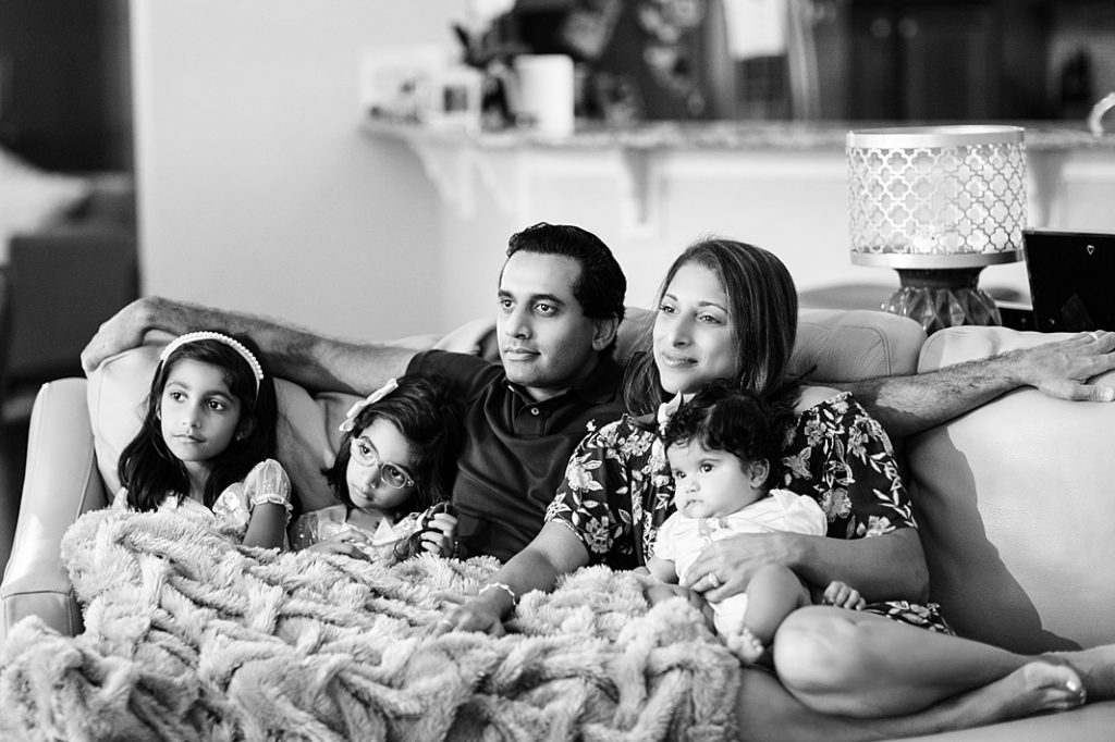 family snuggled on the couch during family storyteller session