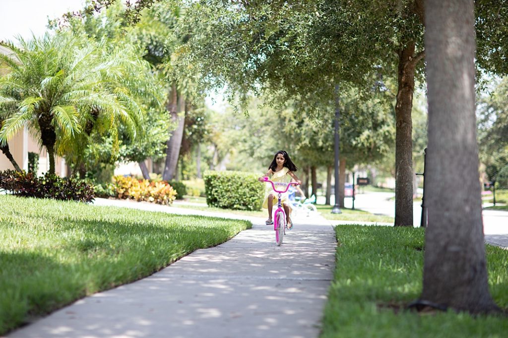 girl riding bike in neighborhood