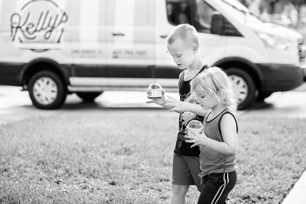 boy and girl holding ice cream and walking