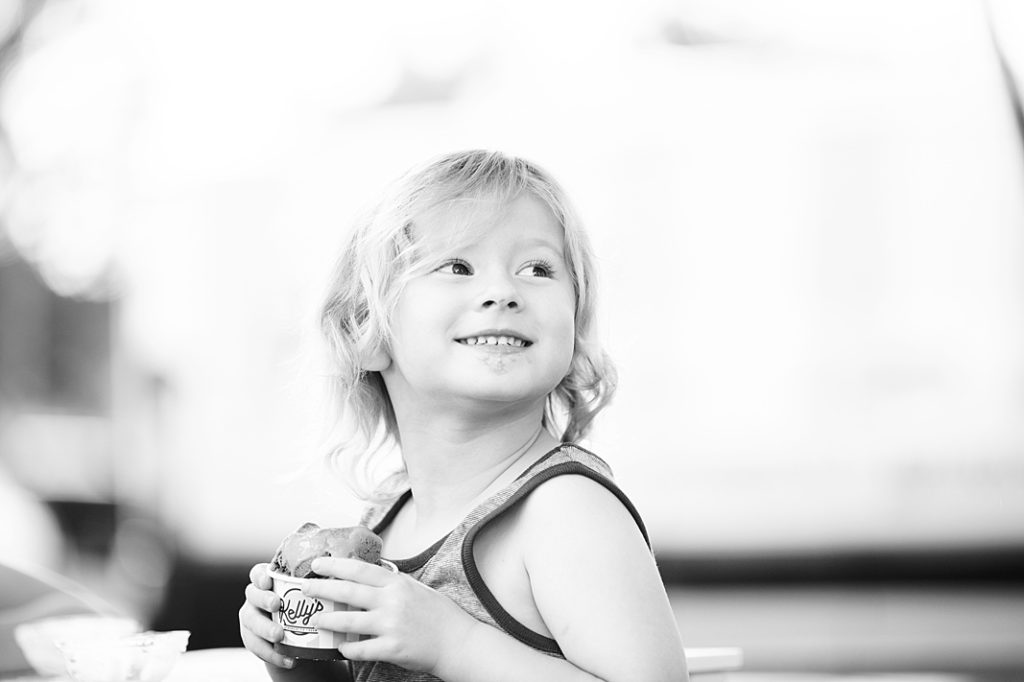 little girl smiling while holding ice cream at summer session